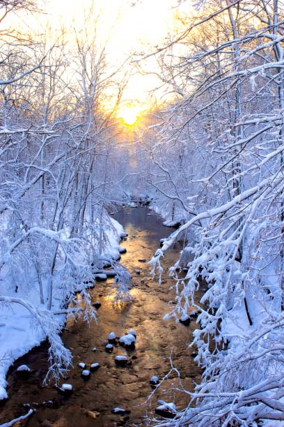 istock Sunrise over snowy Creek after blizzard snow scene 2185587815