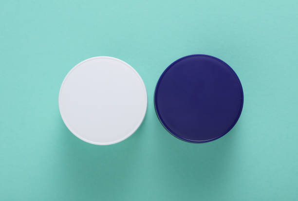 istock Night and day cream jars on mint green background. Top view 2185588831