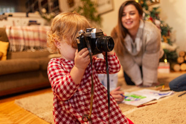 istock Little girl taking pictures with a camera 2185591008