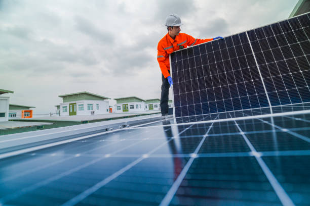 istock engineer man inspects construction of solar cell panel or photovoltaic cell by electronic device. Industrial Renewable energy of green power. factory worker working on tower roof. 2185596368