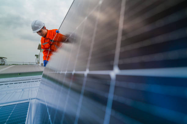 istock engineer man inspects construction of solar cell panel or photovoltaic cell by electronic device. Industrial Renewable energy of green power. factory worker working on tower roof. 2185596499