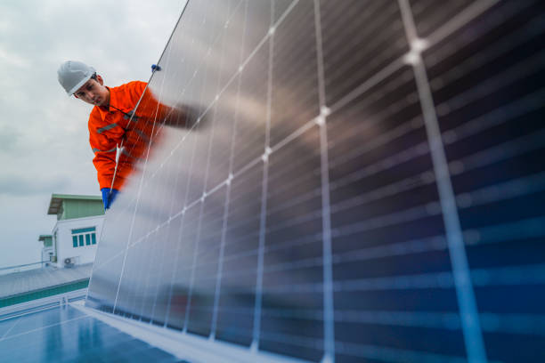 istock engineer man inspects construction of solar cell panel or photovoltaic cell by electronic device. Industrial Renewable energy of green power. factory worker working on tower roof. 2185596565