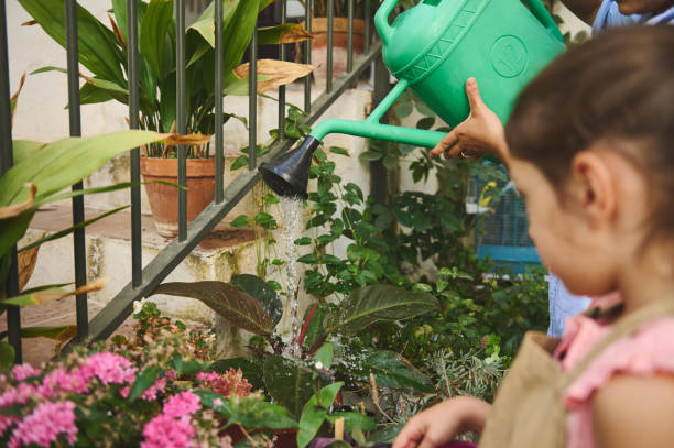 istock Children enjoying a gardening activity with a watering can 2185596575