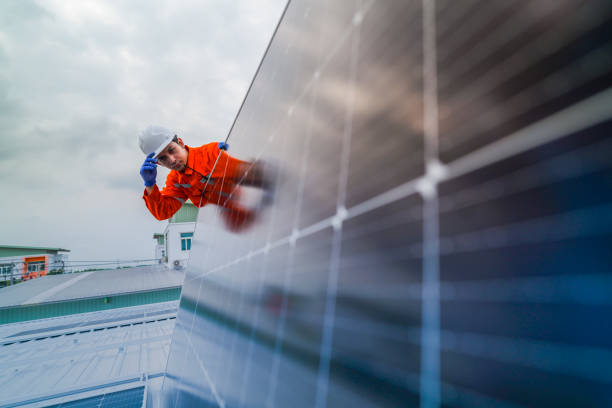 istock engineer man inspects construction of solar cell panel or photovoltaic cell by electronic device. Industrial Renewable energy of green power. factory worker working on tower roof. 2185596637
