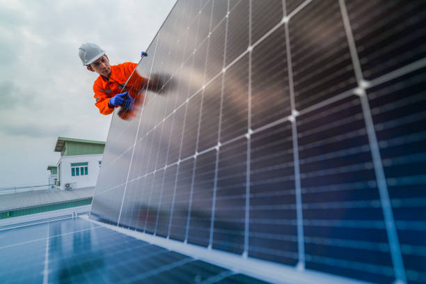 istock engineer man inspects construction of solar cell panel or photovoltaic cell by electronic device. Industrial Renewable energy of green power. factory worker working on tower roof. 2185596920