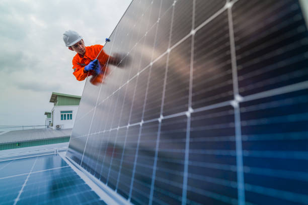 istock engineer man inspects construction of solar cell panel or photovoltaic cell by electronic device. Industrial Renewable energy of green power. factory worker working on tower roof. 2185597189