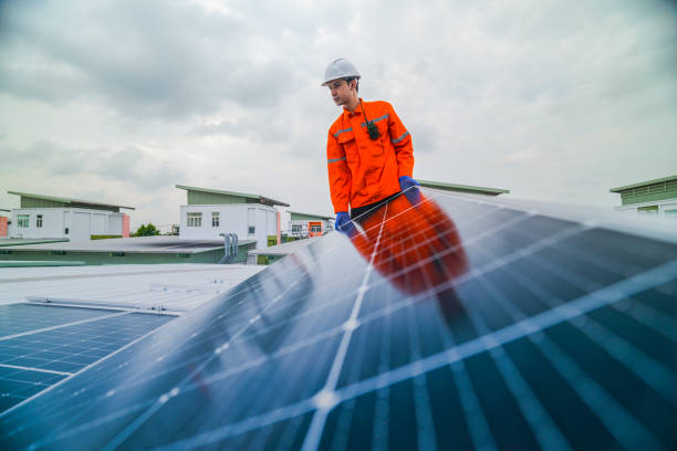 istock engineer man inspects construction of solar cell panel or photovoltaic cell by electronic device. Industrial Renewable energy of green power. factory worker working on tower roof. 2185597245