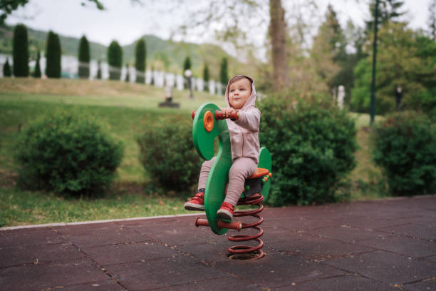 istock Happy Toddler Playing on a Spring Rider at the Park 2185597891