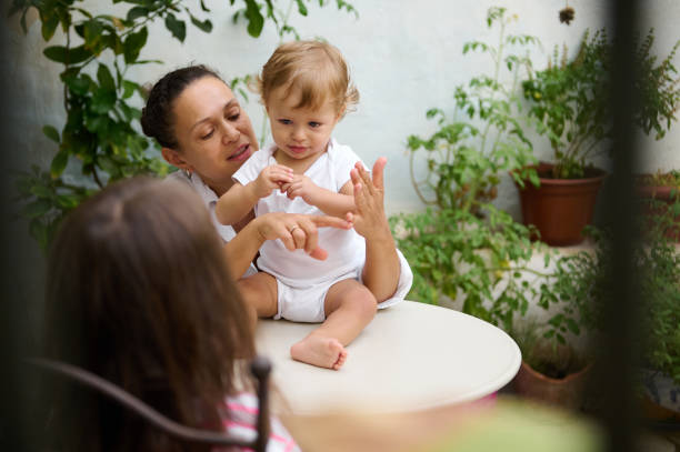 istock Mother and child playing together in a garden setting 2185597946