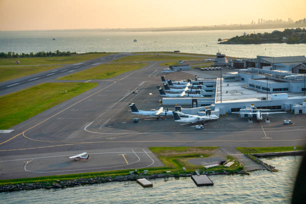 Airplanes along the airport runway at sunset.
