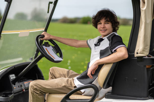 istock Handsome young golfer riding a gold cart and looking contented 2185599485