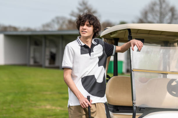 istock Dark-haired caucasian young golfer with a brassie in hand 2185599489