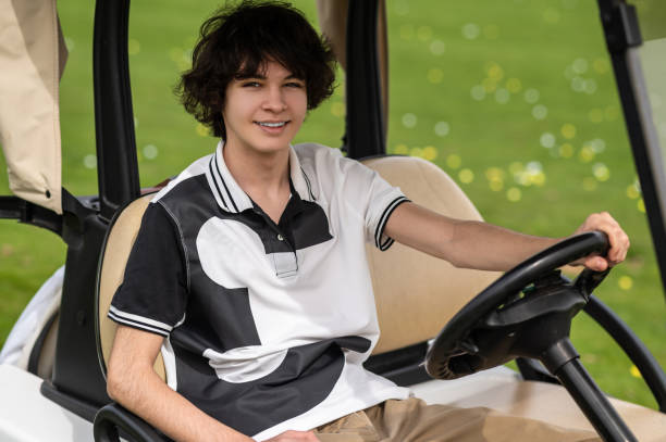 istock Handsome young golfer riding a gold cart and looking contented 2185599494