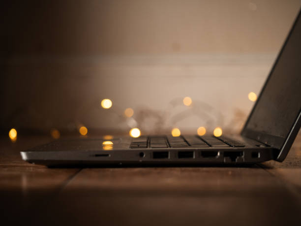 istock Laptop with with twinkling lights background bokeh 2185599794