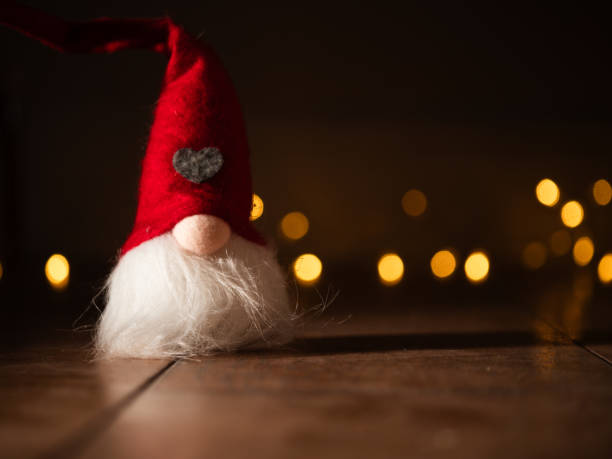 istock Christmas gnome with twinkling lights background bokeh 2185600079