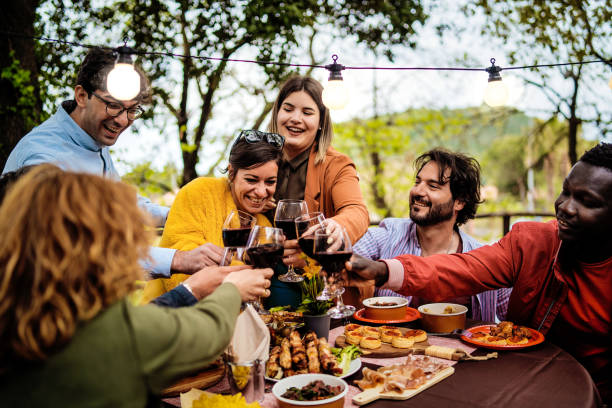 istock Diverse friends enjoying outdoor dinner party with wine and tapas under string lights, multicultural group celebrating in garden 2185600450