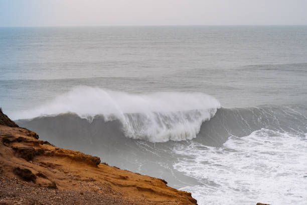 istock Giant ocean wave breaking on a cloudy day 2185601991