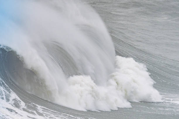 Powerful ocean waves creating white spray as they crash, showcasing the raw energy of nature