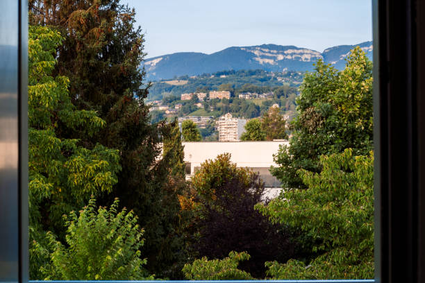 istock Looking at the jura mountains and buildings through a window 2185602439