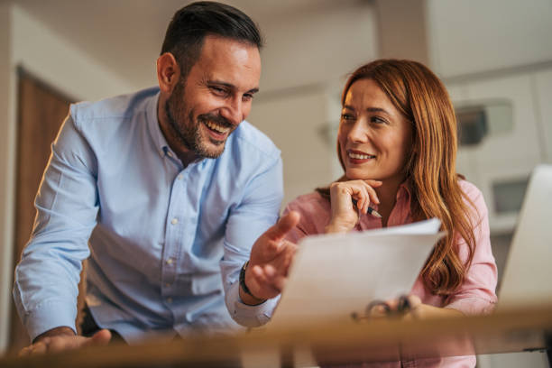 istock A married business couple in the kitchen using a laptop at the table. 2185602480