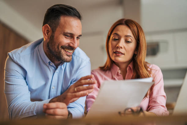 istock A married business couple in the kitchen using a laptop at the table. 2185602551