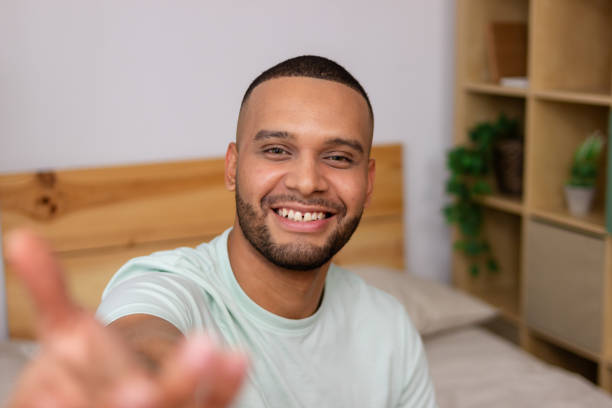 istock Happy young man extending hand for handshake in bedroom 2185608093