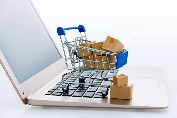 istock Shopping cart with small boxes on laptop keyboard 2185608321