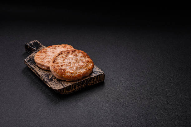 istock Grilled chicken burger cutlet with salt, spices and herbs 2185608352