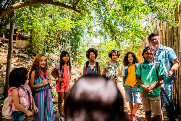 istock Teacher and children during a field trip in a summer camp 2185608433