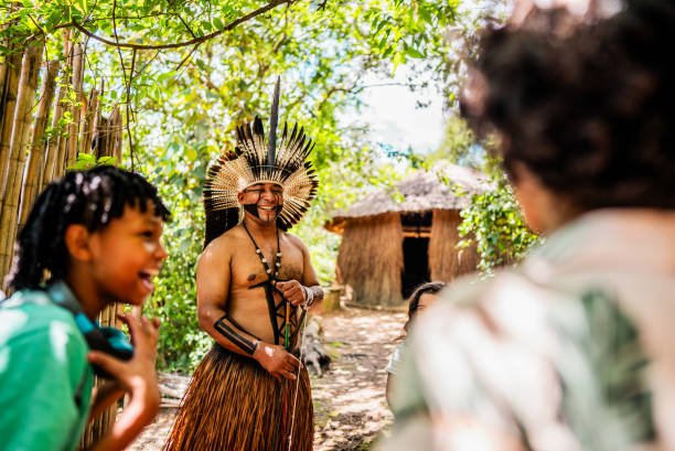 istock Indigenous man talking with children during a field trip to village 2185608459
