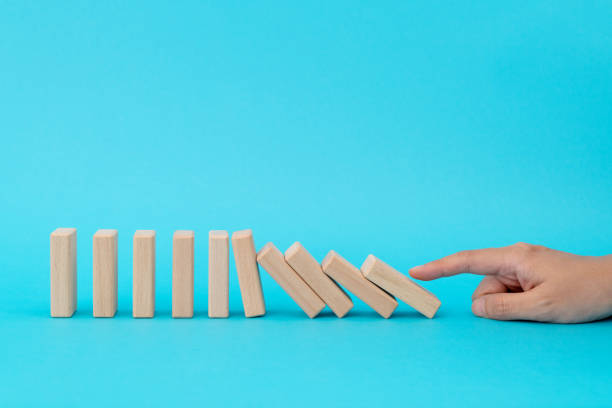 istock Woman hand pushing domino pieces 2185608526
