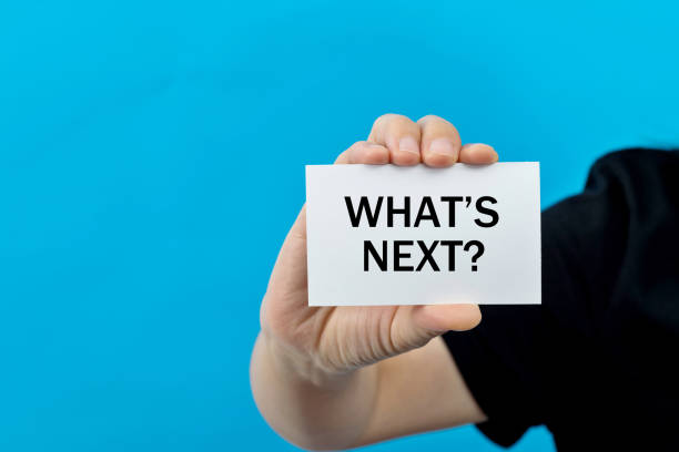 istock Woman hand holding a paper with text what's next 2185608534