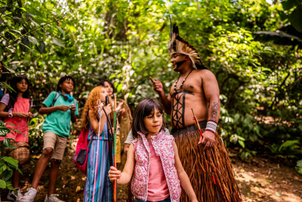 istock Children during a hike with an indigenous man through the forest 2185608884