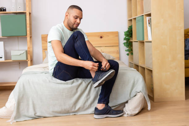 istock Man tying his shoelaces getting ready to go out 2185609233