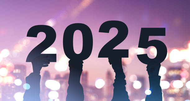 istock People hands holding 2025 year on city blurred bokeh lights 2185609910