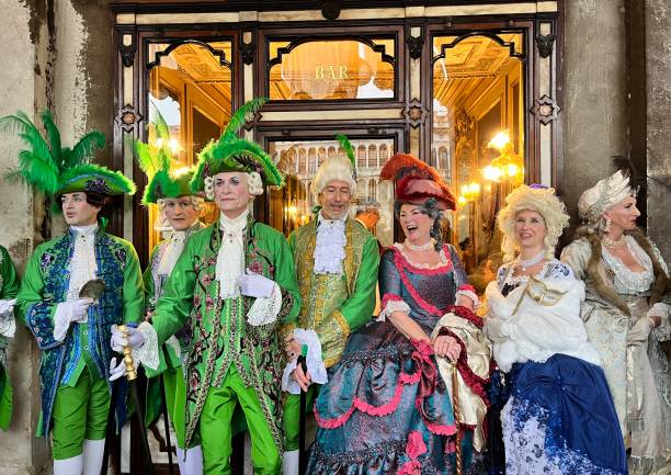 Tourists enjoying wearing costumes in Venice Carnival, Italy Venice, Italy - February 10, 2024: A group of friends enjoying the Venice carnival wearing a costumes while taking a walk around San Marco square in a cloudy raining day. mardi gras body painting stock pictures, royalty-free photos & images