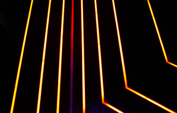 istock Glowing neon stripped lights on dark background 2185613630