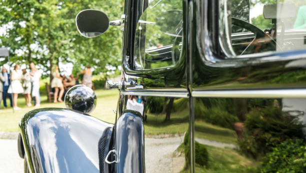 istock Reflection of Wedding Celebrations on a Classic Black Vintage Car 2185615366