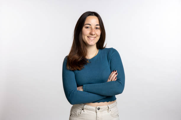 istock young woman in front of white backdrop smiling into camera 2185616375