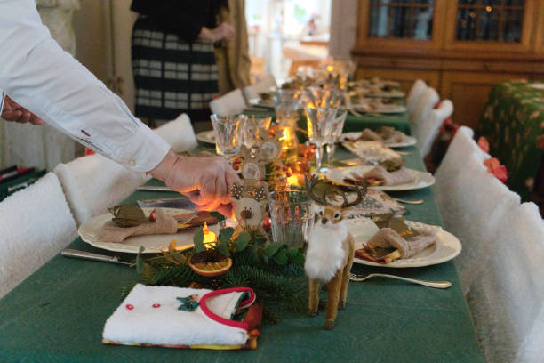 istock Cozy Christmas Table Being Set for a Festive Feast 2185617471