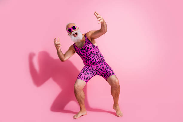 Full size photo of glamour senior man dance disco excited wear leopard print swimsuit isolated pink color background Full size photo of glamour senior man dance disco excited wear leopard print swimsuit isolated pink color background. gay man men sunglasses party stock pictures, royalty-free photos & images