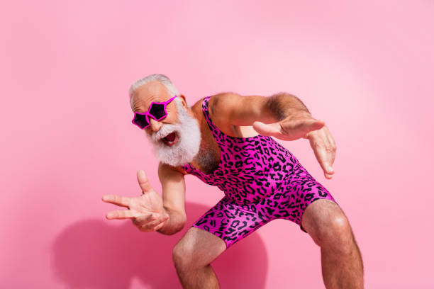 Photo of charismatic elderly cool man have fun dancing good mood wear leopard print overall isolated on pink color background Photo of charismatic elderly cool man have fun dancing good mood wear leopard print overall isolated on pink color background. gay man men sunglasses party stock pictures, royalty-free photos & images
