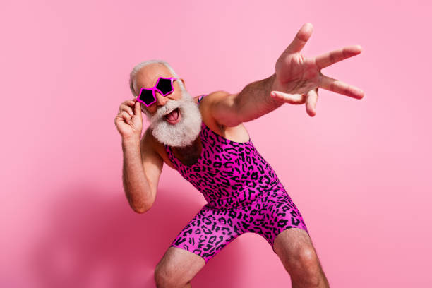 Photo of glamour senior man point you dancing have fun wear leopard print swimsuit isolated pink color background Photo of glamour senior man point you dancing have fun wear leopard print swimsuit isolated pink color background. gay man men sunglasses party stock pictures, royalty-free photos & images
