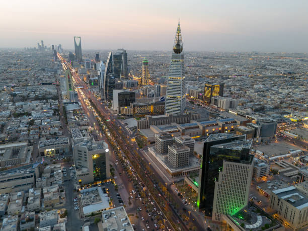 Al Faisaliah Tower pyramid-shaped commercial skyscraper. Riyadh. Drone shot flying. Sunset. Evening.
