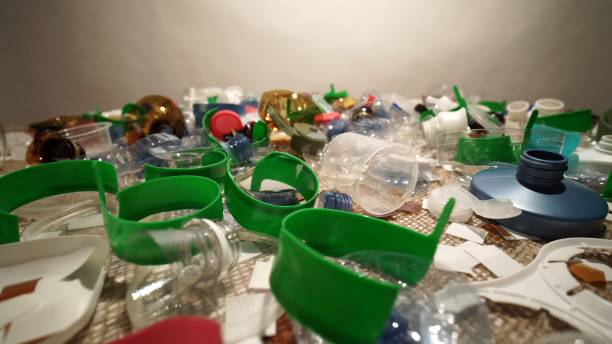 istock Plastic garbage pile from household collected on the table. Single-use or one time use waste discarded. City home trash made of plastic. Empty used bottles and cups create environmental pollution. 2185622500