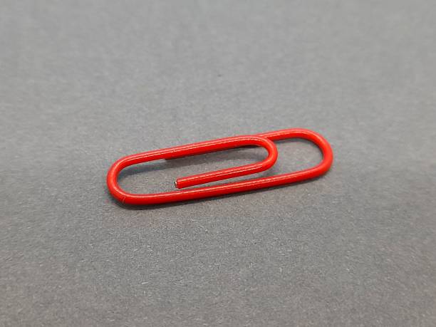 istock One red paper clip with gray background 2185624381
