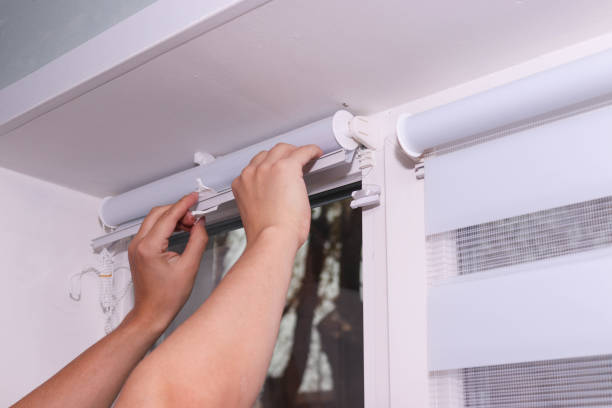 istock Close up of man installing roller blinds on window. 2185627304