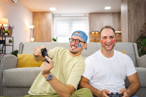 istock Two friends playing video games at home and having fun 2185627845