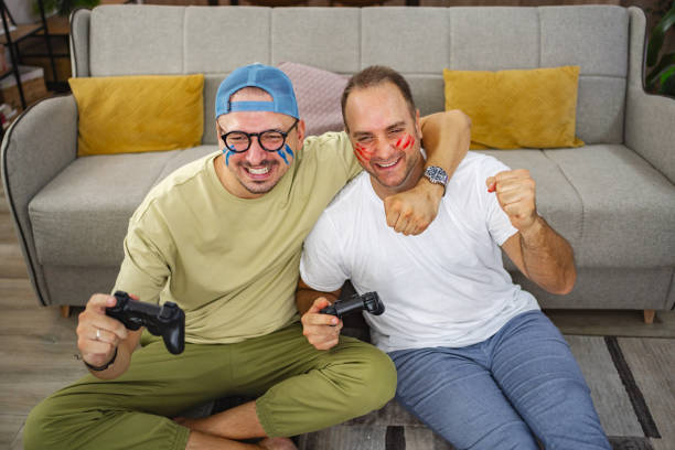 istock Two friends playing video games at home and having fun 2185627847