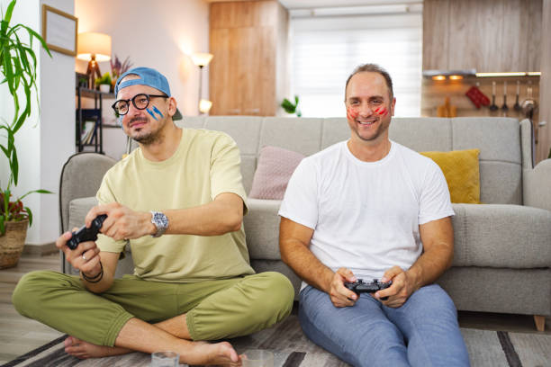 istock Two friends playing video games at home, having fun together 2185628049